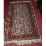 A Persian woollen Qum style rug (worn to one corner) 172x95cm
Provenance: Rushbrooke Estate,