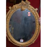 A gilt gesso framed oval wall mirror (re-gilded);