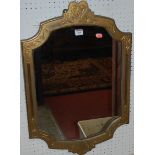 A circa 1900 giltwood floral line carved shaped wall mirror
