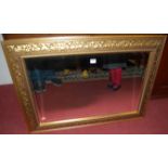 A modern floral gilt framed rectangular bevelled wall mirror