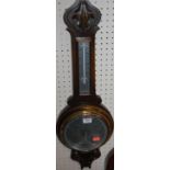 A 20th century oak line carved two-dial aneroid barometer