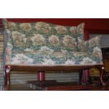 A circa 1900 walnut framed and floral upholstered wingback two seater settee