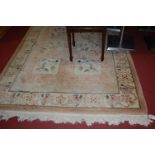 A Chinese superwash beige ground rug with boxed reserves 175x250cm