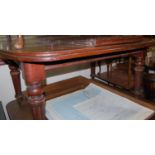 A Victorian mahogany round cornered extending dining table having a wind-out action and single