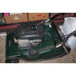 A Hayter Harrier 56 petrol driven lawnmower with grass collecting box and two fuel cans