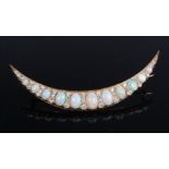 A large Victorian yellow metal opal and diamond crescent moon brooch,