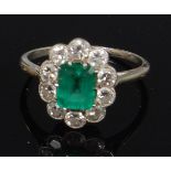 A ladies platinum emerald and diamond cluster ring,