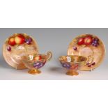 A pair of Royal Worcester porcelain fruit painted teacups and saucers,