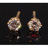 A pair of yellow metal diamond ear studs, the six claw set brilliants each weighing approx 0.