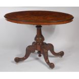 A Victorian figured walnut pedestal centre table, having an oval tilt-top,