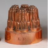 A Victorian copper ring jelly mould, of six turned and fluted sections, monogrammed LR,