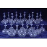 A set of twenty-one late 19th century blown glass wine decanters and stoppers,