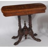 A mid-Victorian figured walnut and floral satinwood inlaid fold-over card table,