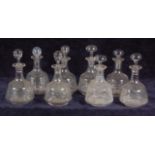 A set of eight late 19th century mallet decanters and associated stoppers,