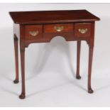 A George III yew wood lowboy, the top having a moulded edge above three frieze drawers,