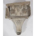 An 18th century lead water hopper, decorated with two flowerheads and a cherub mask,