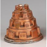 A Victorian copper jelly mould, of four tiered castle-top form, monogrammed LR, h.10.