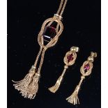 A contemporary 18ct gold garnet set necklace with matching ear studs,