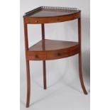 An early 19th century mahogany and satinwood strung bowfront corner washstand,