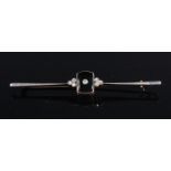 An Art Deco yellow metal and white metal faced diamond and black enamel set knife-edge brooch,