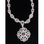 An 18ct white gold and diamond set necklace with matching pendant,