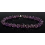 A contemporary beaded amethyst necklace, the graduated beads with flutings, the largest dia. 1.