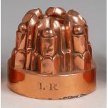 A Victorian copper ring jelly mould, having six turned and ribbed sections,