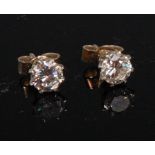 A pair of white metal diamond ear studs, the claw set brilliants each weighing approx 0.
