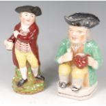 A 19th century Staffordshire Toby jug, modelled standing with a pipe and pitcher of ale, h.