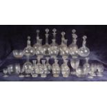 A late Victorian part-suite of glass, comprising; four ewers, three large decanters,