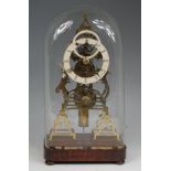 A Victorian brass skeleton clock, having white enamelled chapter ring with Roman numerals,