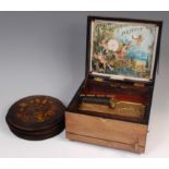 A 19th century small walnut cased polyphon, bearing plaque 'Douglas & Co, South Street,