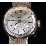 A ladies Omega 14ct gold bracelet watch, having signed circular dial with baton markers,