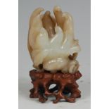 A Chinese Qing Dynasty carved jade finger citron, the back carved with two bats,