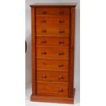 A late Victorian walnut Wellington chest, of eight graduated drawers, having turned wooden knobs,