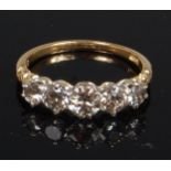 An 18ct gold diamond five stone ring, arranged as five claw set graduated brilliants,