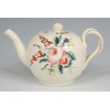 A late 18th century creamware teapot, of bullet shape, the cover with flowerhead finial,
