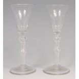A pair of mid-18th century pedestal wine glasses,