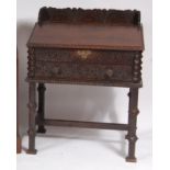 An antique carved oak writing desk,