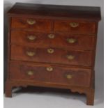 A mid-18th century oak and walnut squarefront chest, of two short over three long drawers,