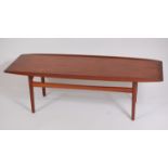 A 1960s Danish teak surfboard coffee table, having raised and slightly curved sides,