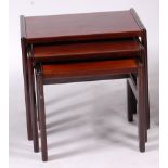 A 1960s Danish rosewood nest of three occasional tables, having integral stretchers, the largest h.