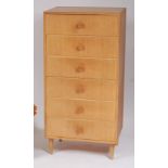A 1950s light oak squarefront chest of six drawers, having integral turned handles,