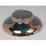 An Art Deco silver capstan inkwell, of circular form, having hinged cover over domed body,