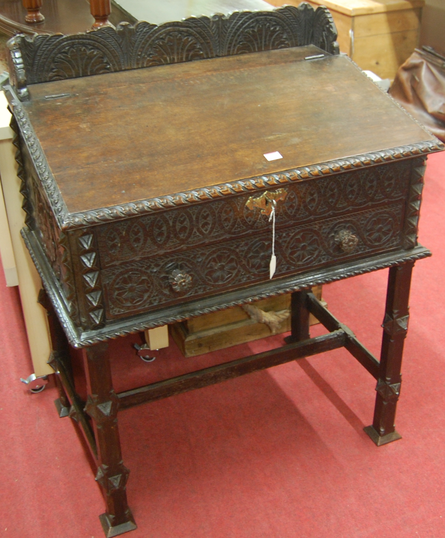 An antique carved oak writing desk,