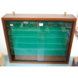 A mid 20th century teak wall hanging collector's cabinet having glass shelves and sliding glass