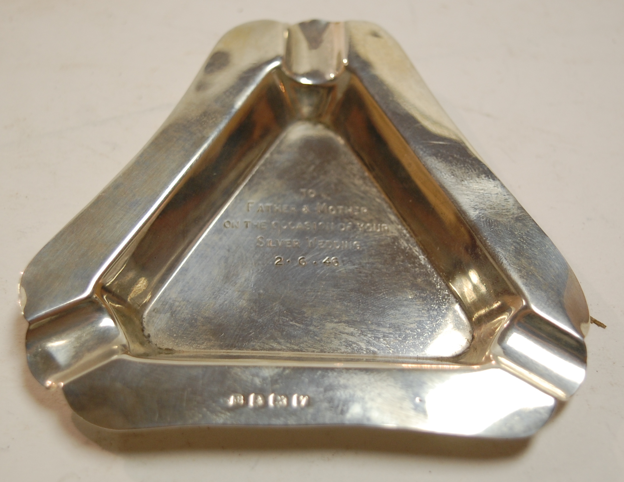 A mid-20th century silver ashtray of triangular form