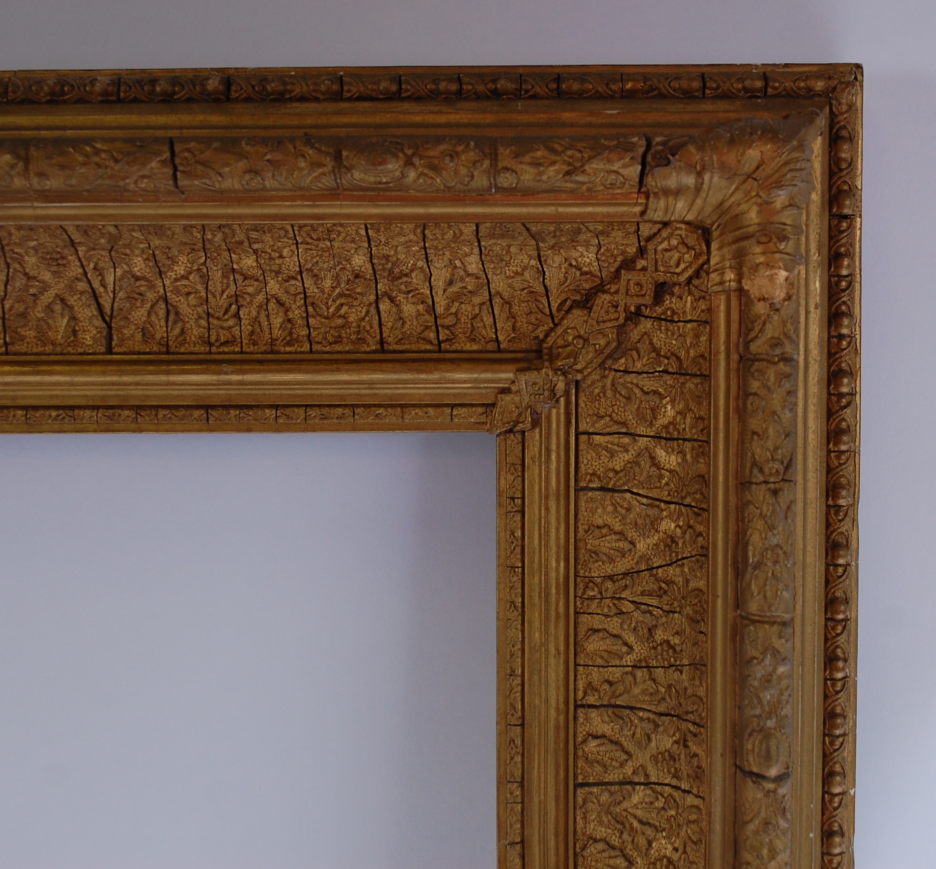 A late 19th century giltwood and gesso picture frame, the whole moulded with leaves and flowers, - Image 2 of 2