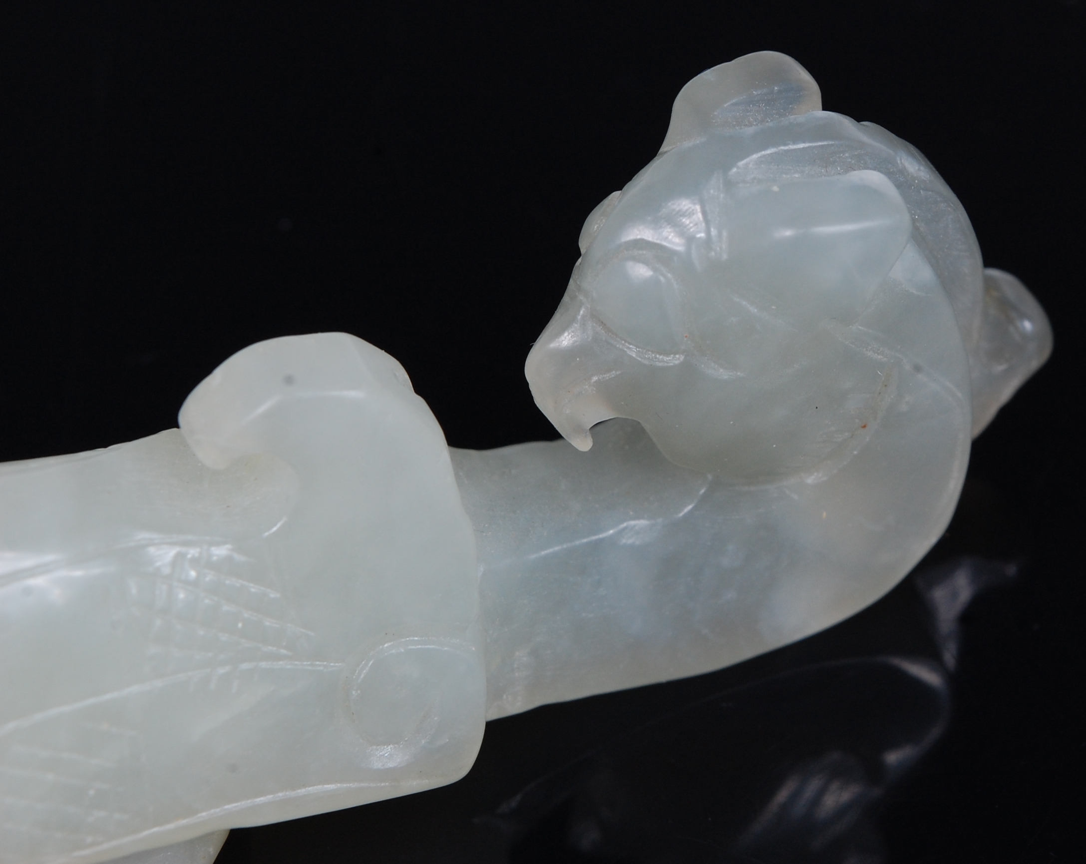 An early 20th century Chinese carved and polished celadon jade belt hook, - Image 2 of 3