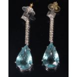 A pair of white metal, diamond and aquamarine ear pendants,